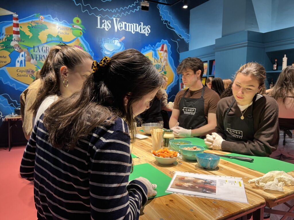 Students cooking together at a table during a student cooking activity in Barcelona